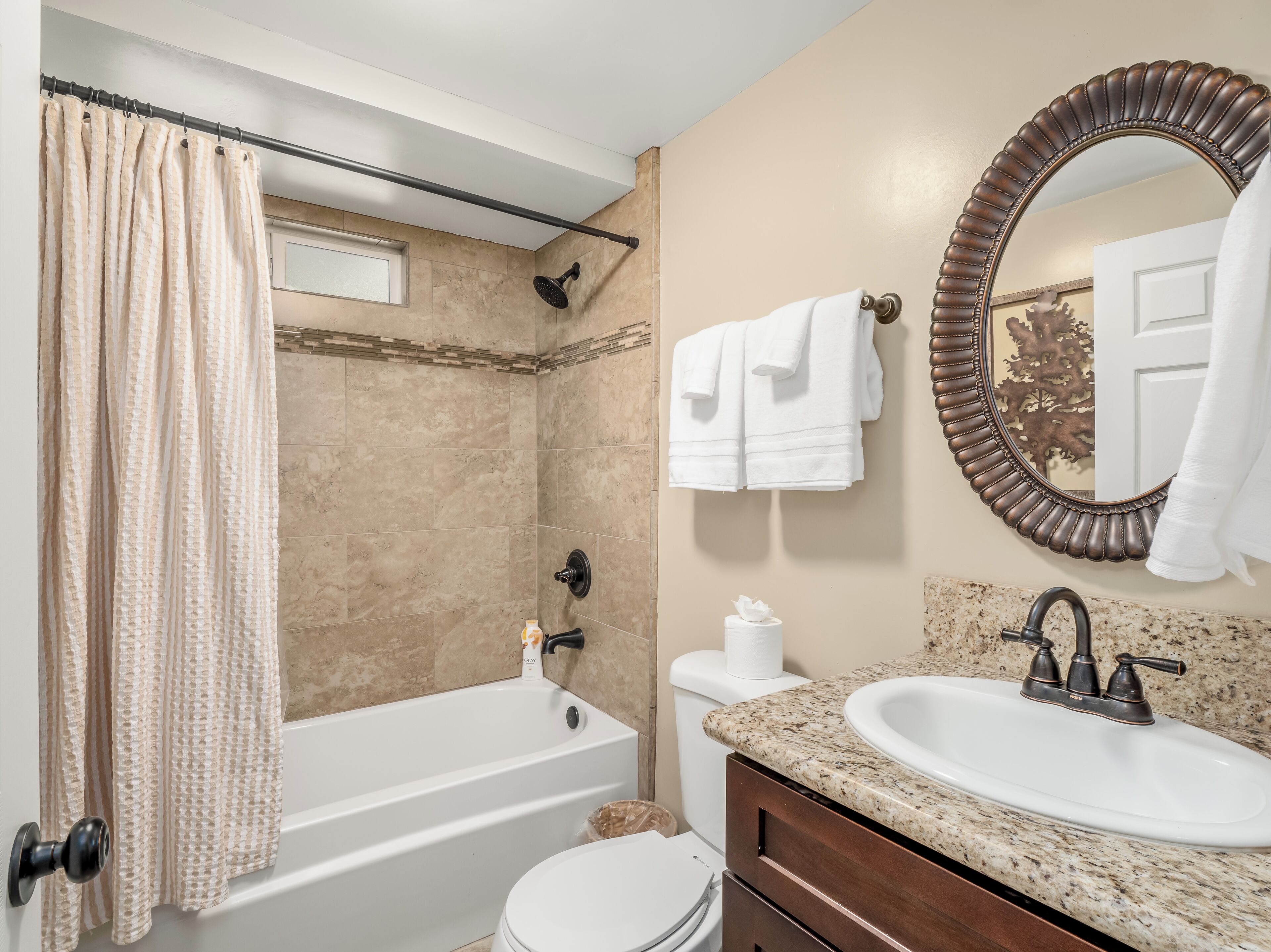 A bathroom with a bathtub, toilet, sink, and a shower.