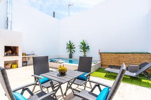 A modern outdoor patio with a pool, seating, and potted plants. - Holiday Home 'Catral Alfalfar' with Private Pool, Wi-Fi and Air Conditioning (Catral)