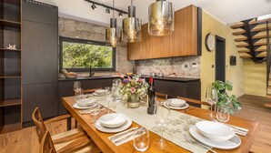 A modern kitchen with a dining area set for six. - Amazing home in Slunj (Slunj)