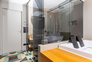 Ein modernes Badezimmer mit Glasdusche, Toilette und Waschbecken.
