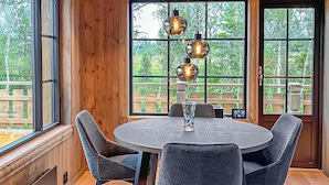 A dining area with a round table, four chairs, and a vase. - 2 bedroom awesome home in Engerdal (Engerdal)