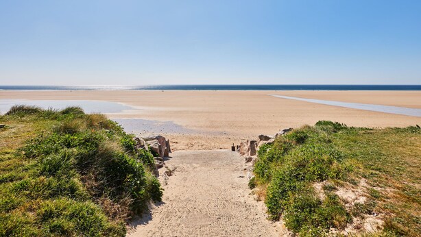 A sandy beach with a clear sky, leading to the sea. - Super Octalia (camping 5*) by Interhome (Les Pieux)