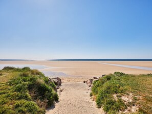 A sandy beach with a clear sky, leading to the sea. - Super Octalia (camping 5*) by Interhome (Les Pieux)