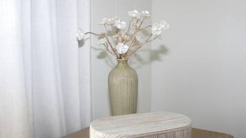 A vase with white flowers on a table.