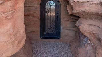Leading to a secluded entrance, this natural passageway offers a glimpse into a unique setting.