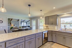 Enjoy cooking in this well-lit kitchen with a large island and appliances.