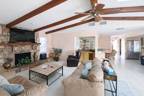 TV, books - Waterfront home with pool, dock accessible to Gulf, dog friendly with AC & WD (Osprey)