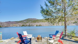 A lakeside deck with Adirondack chairs and a fire pit. - Paddle, Swim & Hike: Family Lake House in Vermont (Tinmouth)