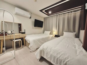A hotel room with two beds, a desk with a chair, a flat-screen TV, an air conditioning unit, and a window with curtains. - AnOn hostel (Seoul)