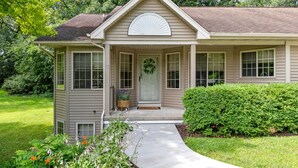 A two-story house with a front porch, a covered entryway, and a well-maintained lawn. - Oak Haven Retreat, Oak Haven Retreat  - Charming Green Lake Property (Princeton)