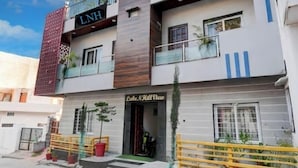 A two-story building with balconies, a visible sign for 'LNH', and a storefront named 'Lake N Hull View'. - Lake N Hill View (Udaipur)