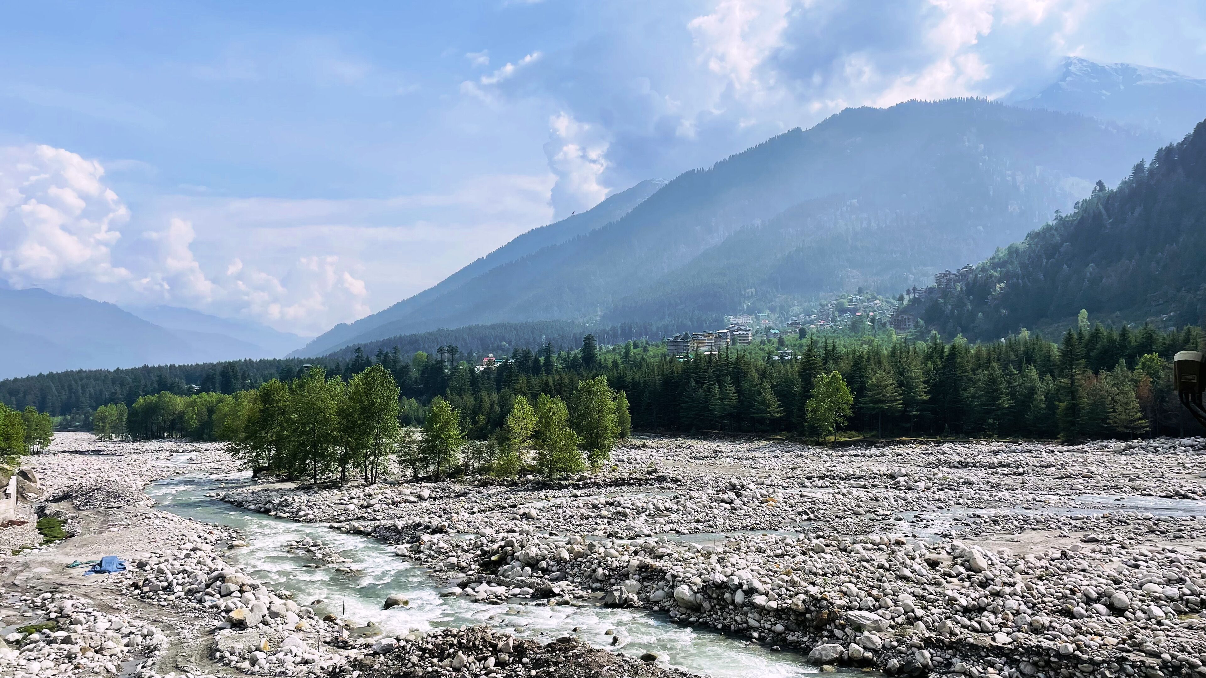 Un río serpentea por un paisaje rocoso con montañas al fondo.