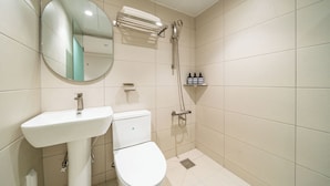 A bathroom with a sink, toilet, mirror, and shower. - Cream Hotel (Guri)