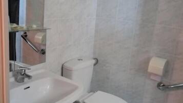 Ein Badezimmer mit Waschbecken, Toilette und Spiegel.
