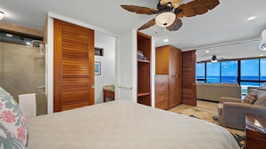 Ein Schlafzimmer mit einem großen Bett, einem Holzschrank und einem Deckenventilator.