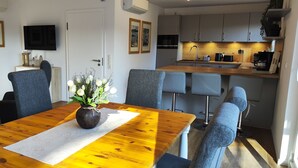 A modern kitchen with grey cabinets, a wooden countertop, and a built-in oven. - Chalet on the Diemelsee with lake view, sun terrace and much more. Pet friendly (Diemelsee)