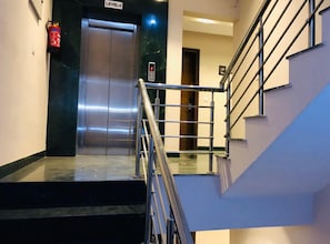 Access the upper floors via the LEVEL-2 elevator or staircase with metal railing.