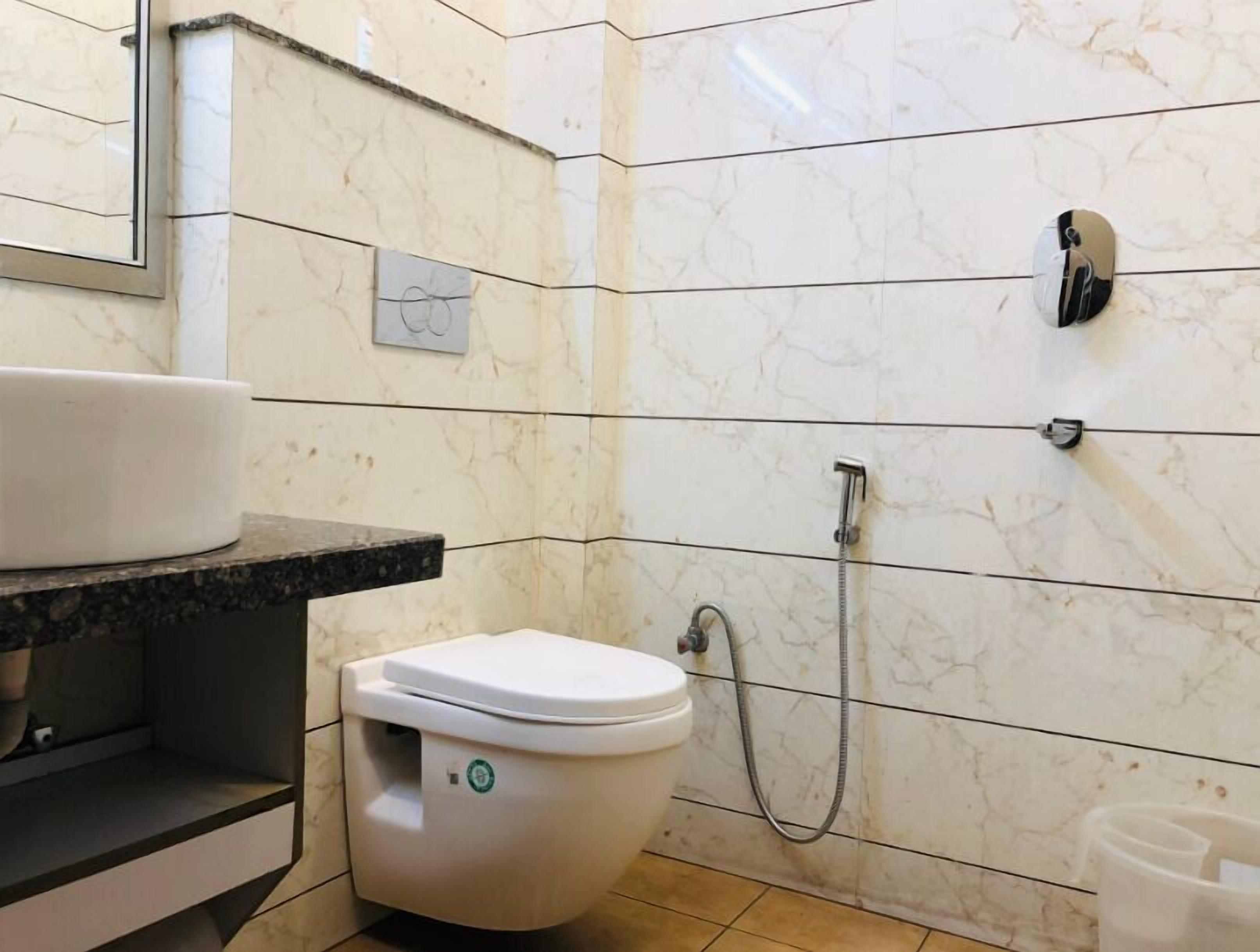 A bathroom with a toilet, a sink, and a shower.