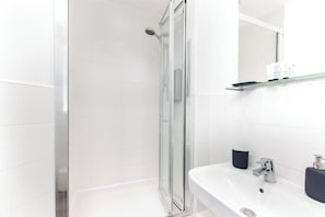 Shower, hair dryer, towels, toilet paper
