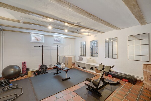 A home gym with exercise equipment, a bench, and a weight bench.