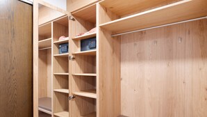 A wooden closet with multiple shelves and a flat storage area.