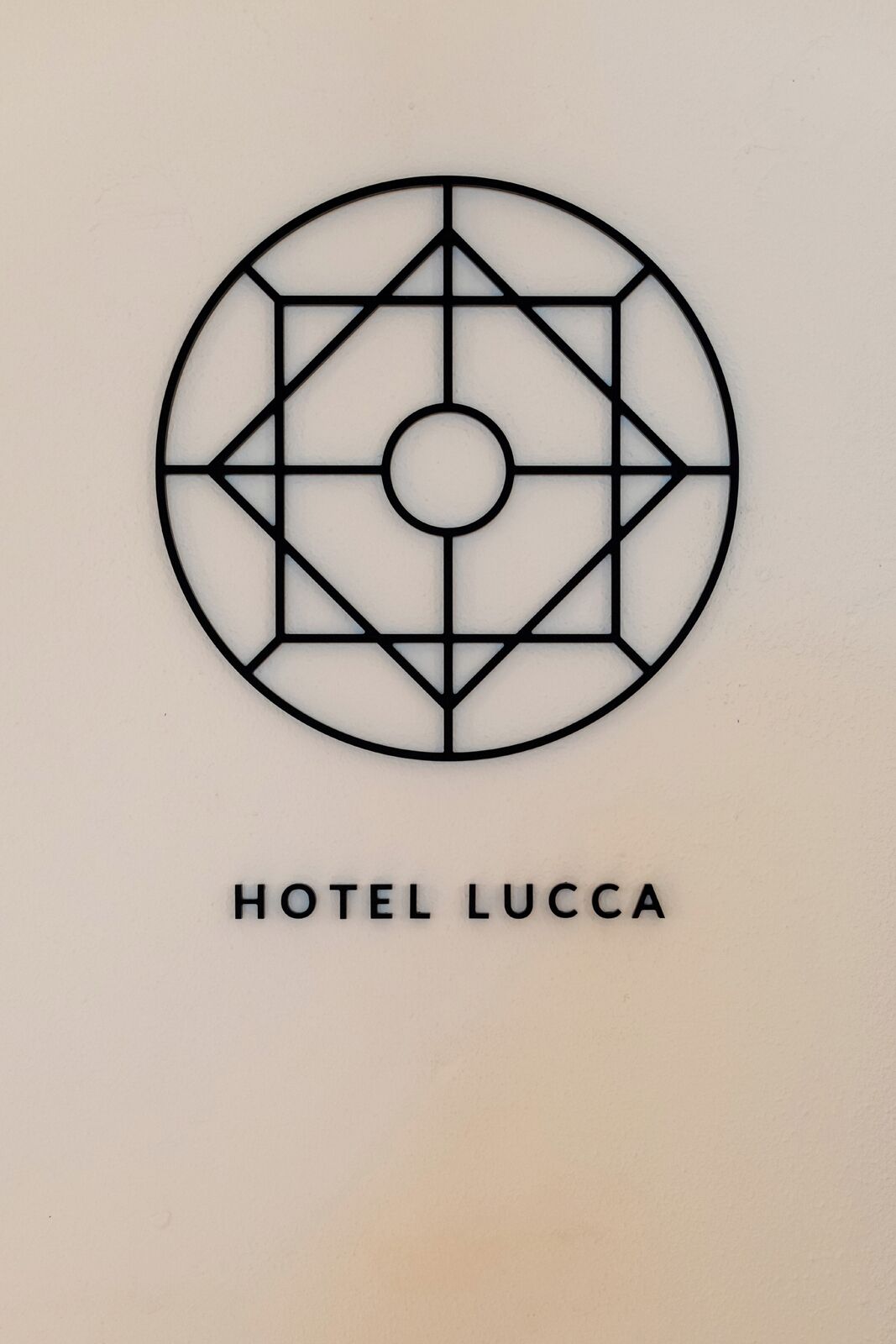 A geometric logo with the text "HOTEL LUCCA" below it.
