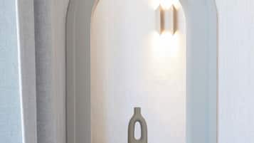 A white arched window with a small vase inside.