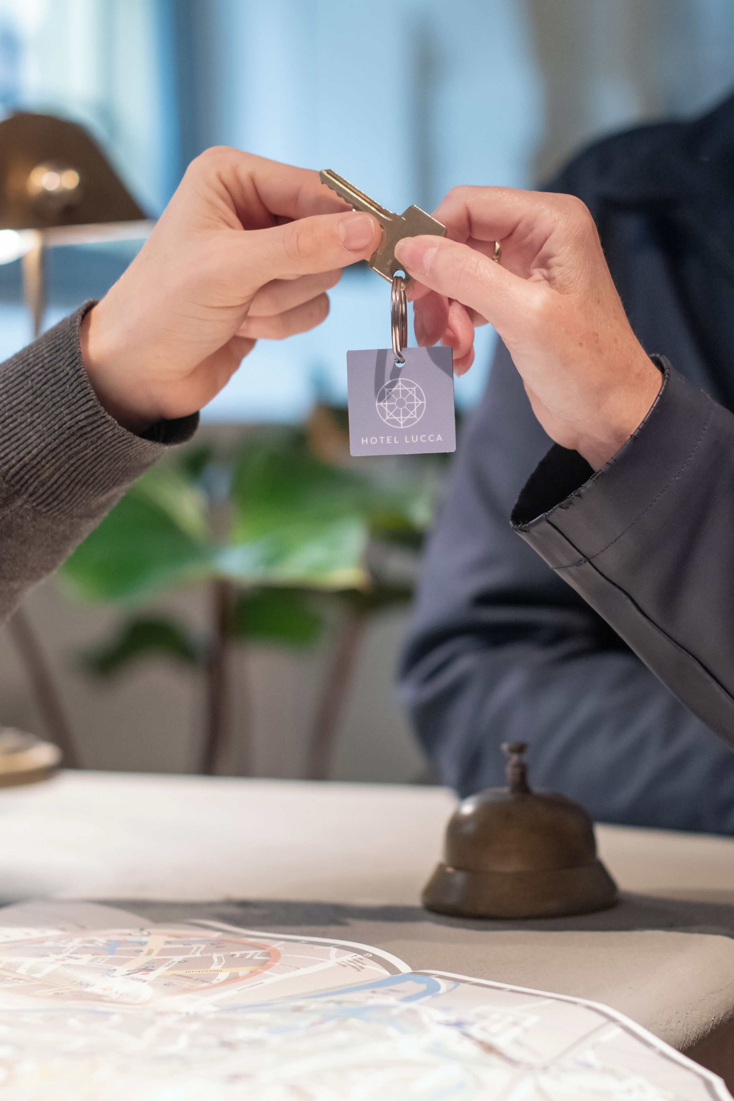 A person handing over a key to another person.