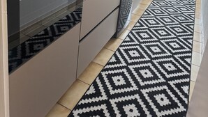 Une cuisine moderne équipée d’un four encastré, d’un four à micro-ondes et d’un lave-vaisselle.