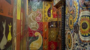A corridor with walls adorned with colorful, intricate patterns and designs.