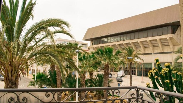 A building with a modern architectural style, featuring a flat roof and large windows. - Carmina Apartments (Carboneras)