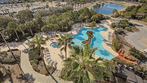 A resort with a large swimming pool, palm trees, and a view of the city. - 6th Floor Studio Condo in Luau at Sandestin Golf & Beach Resort! (Miramar Beach)