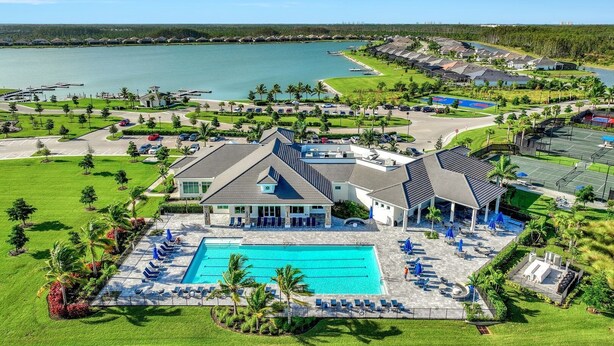 A resort with a swimming pool, tennis courts, and a view of the water. - Wildblue - William Raveis Rentals (Ft. Myers)