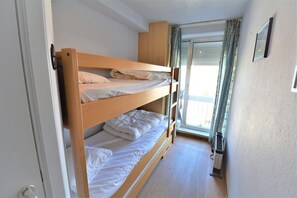 A bunk bed room with a window, curtains, and a radiator. - Penthouse With Large sun Terrace (Knokke-Heist)