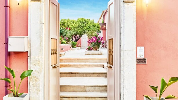 A hotel entrance with a staircase leading to a covered area with plants and flowers. - Arhontiko Arhanes - Cretan Fairytale Gem With Pool (Archanes-Asterousia)