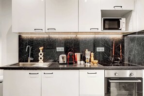 Fridge, microwave, stovetop, coffee/tea maker