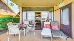 An outdoor patio with a dining table, chairs, and a sofa. - Oceanfront Condo w/ Pool Access on Molokai! (Maunaloa)