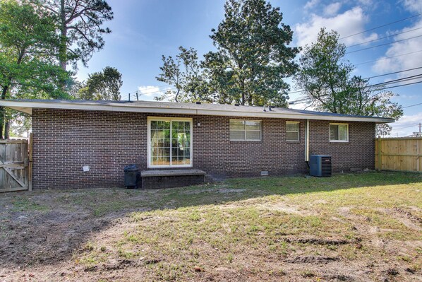 A single-story brick house with a front porch, a garage door, and a small front yard. - 7 Mi to Dtwn: Family-friendly Augusta Home w/ Yard (Augusta)