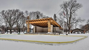 A covered outdoor area with a wooden structure, possibly a pavilion, surrounded by snow. - Cozy Cedarburg House - Walk to Historic Downtown! (Cedarburg)