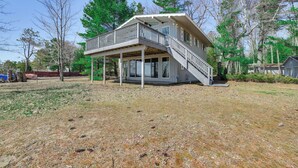 A two-story house with a balcony and a covered porch. - Private Beach: Waterfront Home on Lake Huron! (Greenbush)