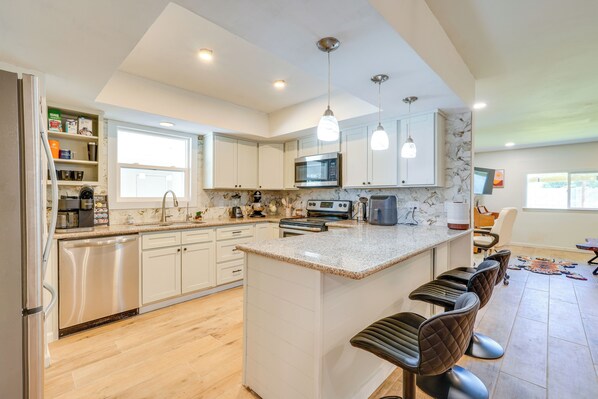 Enjoy cooking in this well-equipped kitchen with a central island, bar stools, and ample counter space.