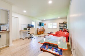 Cozy living space with a comfortable seating area, dedicated workspace, and children's play area.