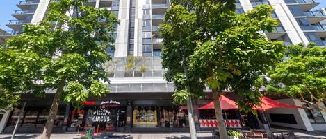 A modern building with a restaurant named 'Archie Brothers' at street level.