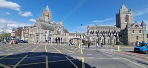 A historic building with a prominent tower and arched windows.
