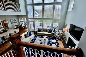 A spacious living area with a large window, a fireplace, and a dining area. - New Listing * 7 BR Coastal Club Resort Style Luxur (Lewes)