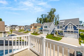 A residential neighborhood with houses featuring front porches, garages, and well-maintained lawns. - Sleeps 12 | Pool + Game Room | Central Location (Rehoboth Beach)