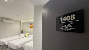 A modern hotel room with two beds, a painting of pyramids, and a sign indicating room number 1408. - Dar Pyramids View Inn RoofTop (Giza)