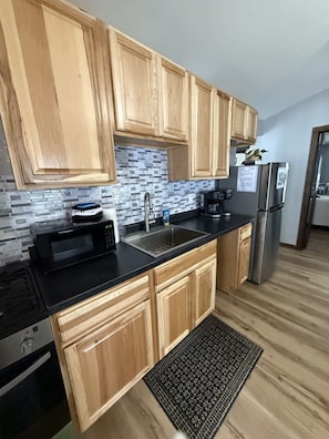 Fridge, microwave, stovetop, coffee/tea maker