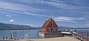 A wooden dockside bar and restaurant with a red building, a pier, and boats on the water. - Wsh1030 - Camp Westwater 4 Bedroom Home (Tahoma)