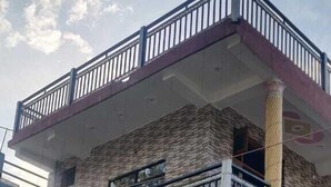 A two-story building with a sign for "Hotel Kamal Ganga & Restaurant" on the ground floor. - Hotel Kamal Ganga & Restaurant (Rajgarhi)